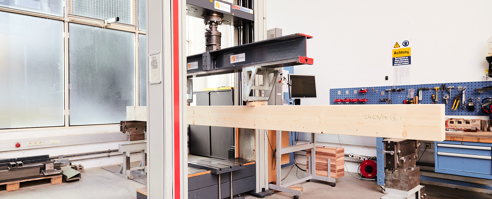 Bending testing machine with inserted bar-shaped building product in the testing hall in the Arsenal.